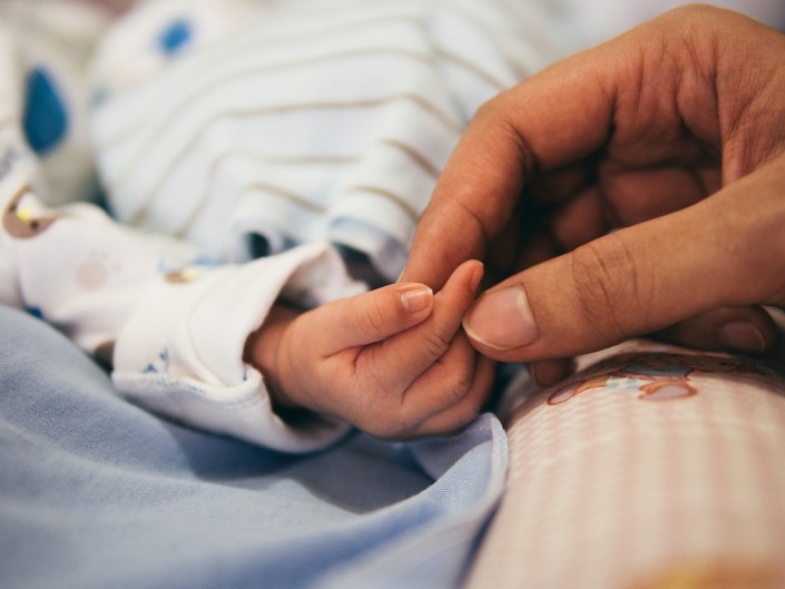 Adult & baby hands sleep