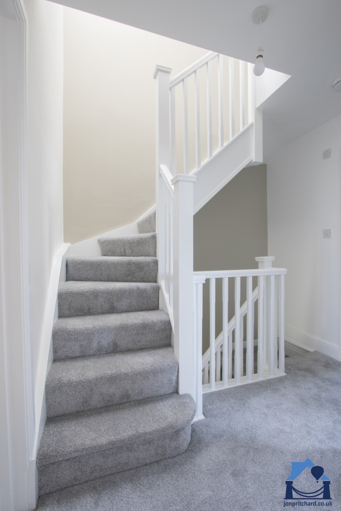 Loft conversion staircase, Full size, Light grey carpet and white painted modern square spindles, handrails etc