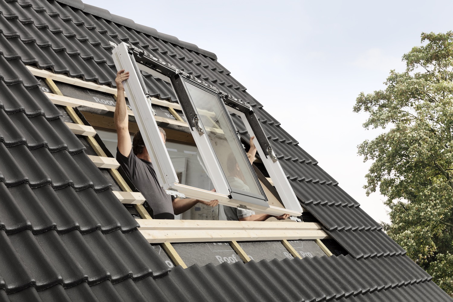 VELUX roof windows being installed in a loft conversion exterior roof image